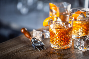 Old fashioned classic rum cocktail on ice with orange zest garnish - obrazy, fototapety, plakaty