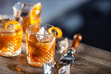 Old fashioned rum drink on ice with orange zest garnish - obrazy, fototapety, plakaty