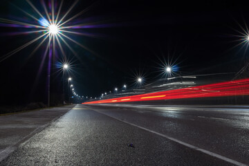 Fototapeta na wymiar Car light trail and city light. Night shot. Vehicle back lights illumination on highway