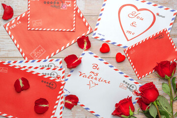 Red roses in bouquets. Letters, mail, vintage wooden background. The inscriptions 