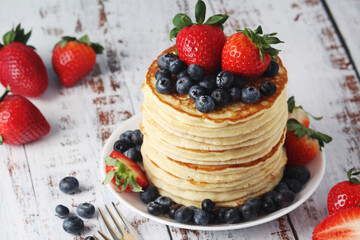 A stack if home-made pancakes with berry