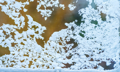 Snow and ice on a window glass looking into a snowy garden in winter, Almere, Flevoland, The Netherlands, February 7, 2020