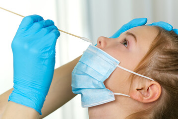 Pediatrician or doctor taking nasal mucus test, covid - 19 test . covid virus testing procedure...
