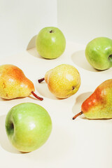 Icometric view of pears and apples in sunlight. Modern composition.
