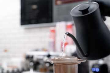 Making press coffee. Add watter over natural background.