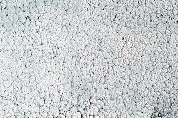 Old background with very cracked white paint on wall, grunge rough surface, dirty weathered empty lettering template design.