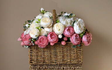 Fototapeta na wymiar Basket of flowers on neutral background. 