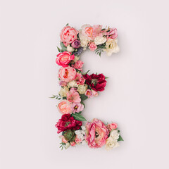 Letter E made of real natural flowers and leaves. Flower font concept. Unique collection of letters and numbers. Spring, summer and valentines creative idea.