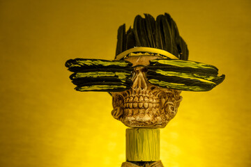 skull crowned with feathers and yellow background, Indian crown, skull concept