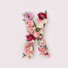 Letter X made of real natural flowers and leaves. Flower font concept. Unique collection of letters and numbers. Spring, summer and valentines creative idea.