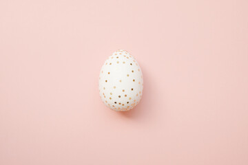Easter white egg with glitter stars on pastel pink background. Minimal  concept. Happy Easter card with copy space for text. 