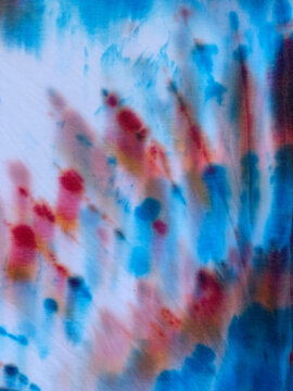 Close up of red, white and blue, tye-dyed cotton t-shirts