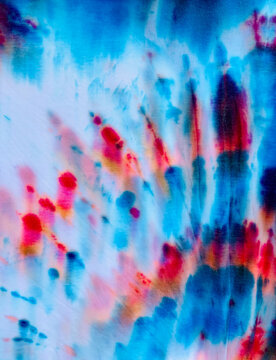 Close up of bright red, white and blue, tye-dyed cotton t-shirts