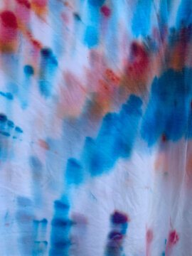 Close up of red, white and blue, tye-dyed cotton t-shirts