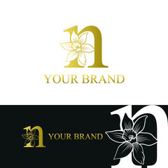 Golden Luxury Initial letter n with March Daffodils narcissus flower for cosmetic, Jewelry, boutique, hotel logo concept vector