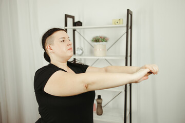Fototapeta na wymiar Overweight woman exercising in her living room