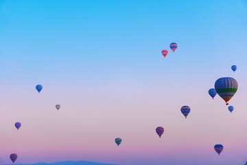 Balloons on a background of a purple blue sky. Balloons with baskets fly over Cappadocia on an...
