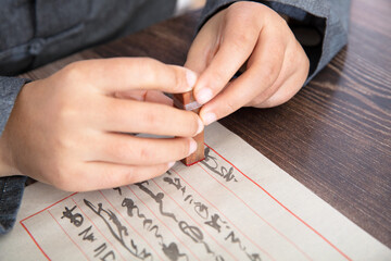 Take the seal in hand and sign the letter