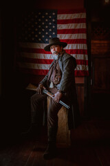 Fototapeta premium Cowboy posing with rifle gun on hand to show protected weapon ,vintage style.