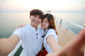 Valentine concept, Joyful young loving couple do selfie togeher on bride at outdoor, Young Couple Pose For Holiday Selfie On Clifftop