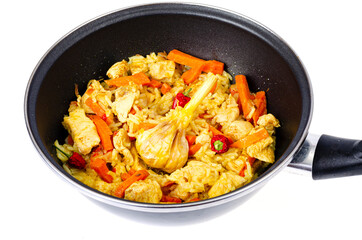 Pilaf. Rice with meat and vegetables in frying pan on white background. Studio Photo