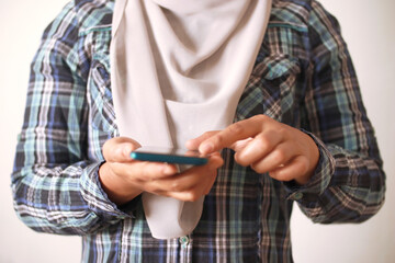 Close up of woman holding and using smart mobile phone, scrolling browsing internet on gadget