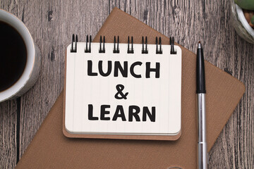 Lunch and Learn, text words typography written on book against wooden background, life and business...