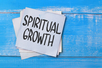 Fototapeta na wymiar Spiritual Growth, text words typography written on book against blue background, life and business motivational inspirational