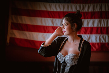 Beautiful sexy cowgirl posing vintage style with untied state 
flag background.