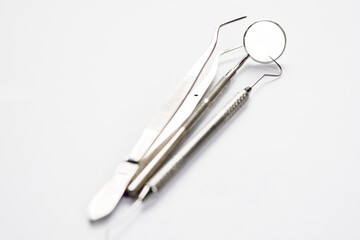 Basic dentist tools on white background.