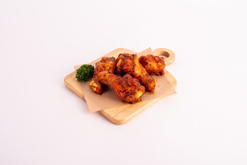Baked chicken wings pepper on white background.