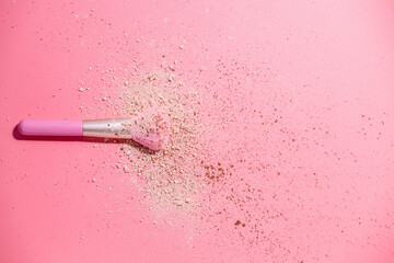 Make up brushes with powder on pink background