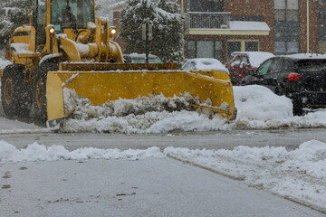 Snow remover truck cleaning city streets in snow storm