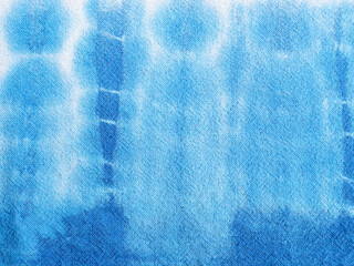 Close up indigo tie-dye on beige cotton fabric texture.