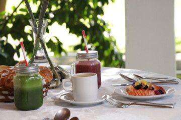 gourmet breakfast in a sunny restaurant with fruit, coffee and juice