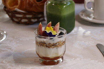 gourmet fruit cocktail with fig, berries, muesli, yoghurt and juice