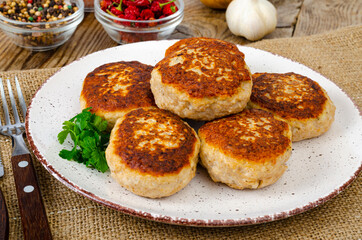 Homemade meat cutlets on wooden table. Studio Photo
