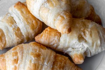 A plate of delicious golden, warm miniature croissants, photographed up close, in Toronto, Ontario, Canada, February 2021. 