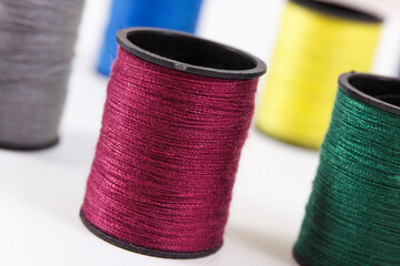 Spools of colorful thread as accessories for using in sewing.