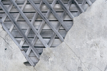 Old brocken plaster house walls with crossed wooden strips