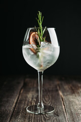 Gin based cocktail with triple sec in wine glass on the rustic background. Selective focus. Shallow depth of field. 