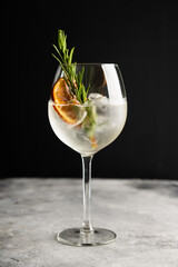 Gin based cocktail with triple sec in wine glass on the rustic background. Selective focus. Shallow depth of field. 