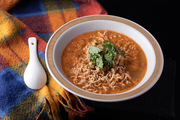 Mama Tom Yum Soup in a Cup on Black Background