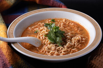 Mama Tom Yum Soup in a Cup on Black Background