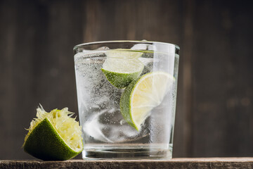 Rum based cocktail caipirinha (variation of cuba libre) on the rustic background. Selective focus. Shallow depth of field.