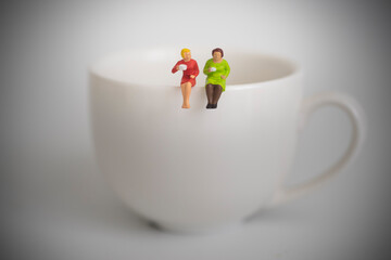 Two women sipping coffee together