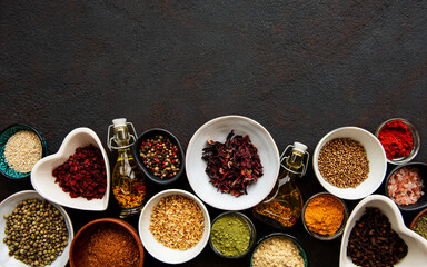 Various spices in a bowls on a black