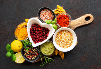 Dry seasonings and spices against a dark background view from the top.