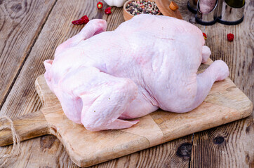 Raw chicken carcass on kitchen cutting board. Studio Photo