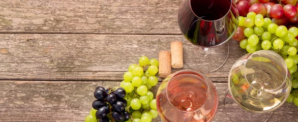 Tuinposter Variety of wine and snack set. Different types of grapes. Fresh ingredients on wooden background. © bit24